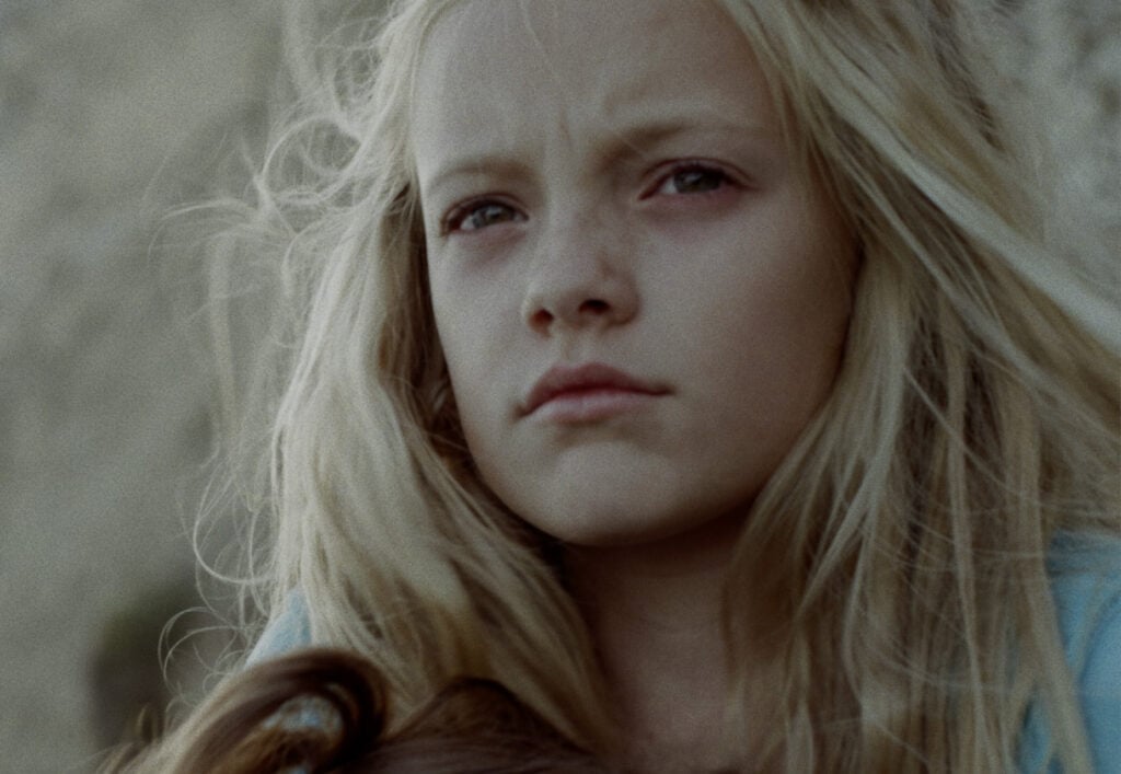 A young girl looking past the camera
