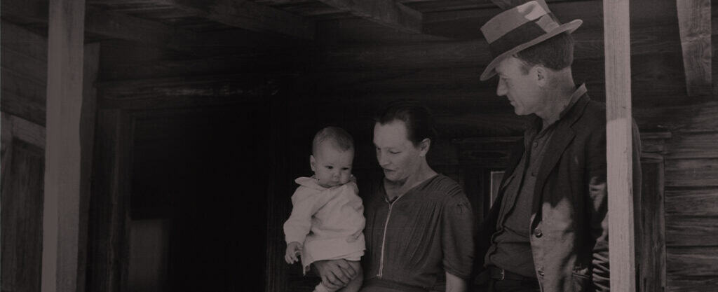 This history of adoption header shows an old black and white photo of a mother holding her adopted infant.