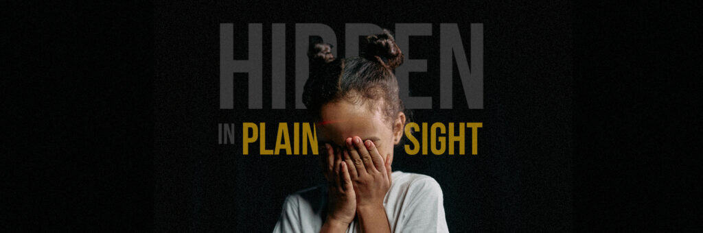 A girl covers her eyes with her hands to convey the hidden foster care crisis.