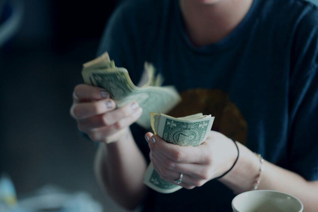 Financial insecurity is a significant barrier to family reunification, including this mother who counts her limited cash.