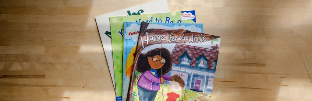 Four of the best books for children in foster care stacked on top of each other.