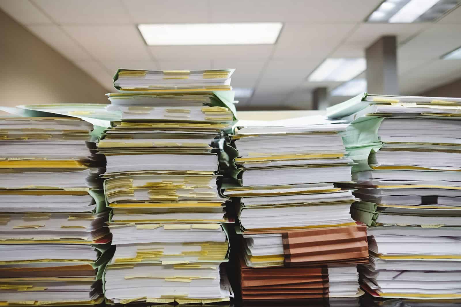 Foster care prevention funding is a small share of child welfare spending, like these stacks of case files on an office desk.