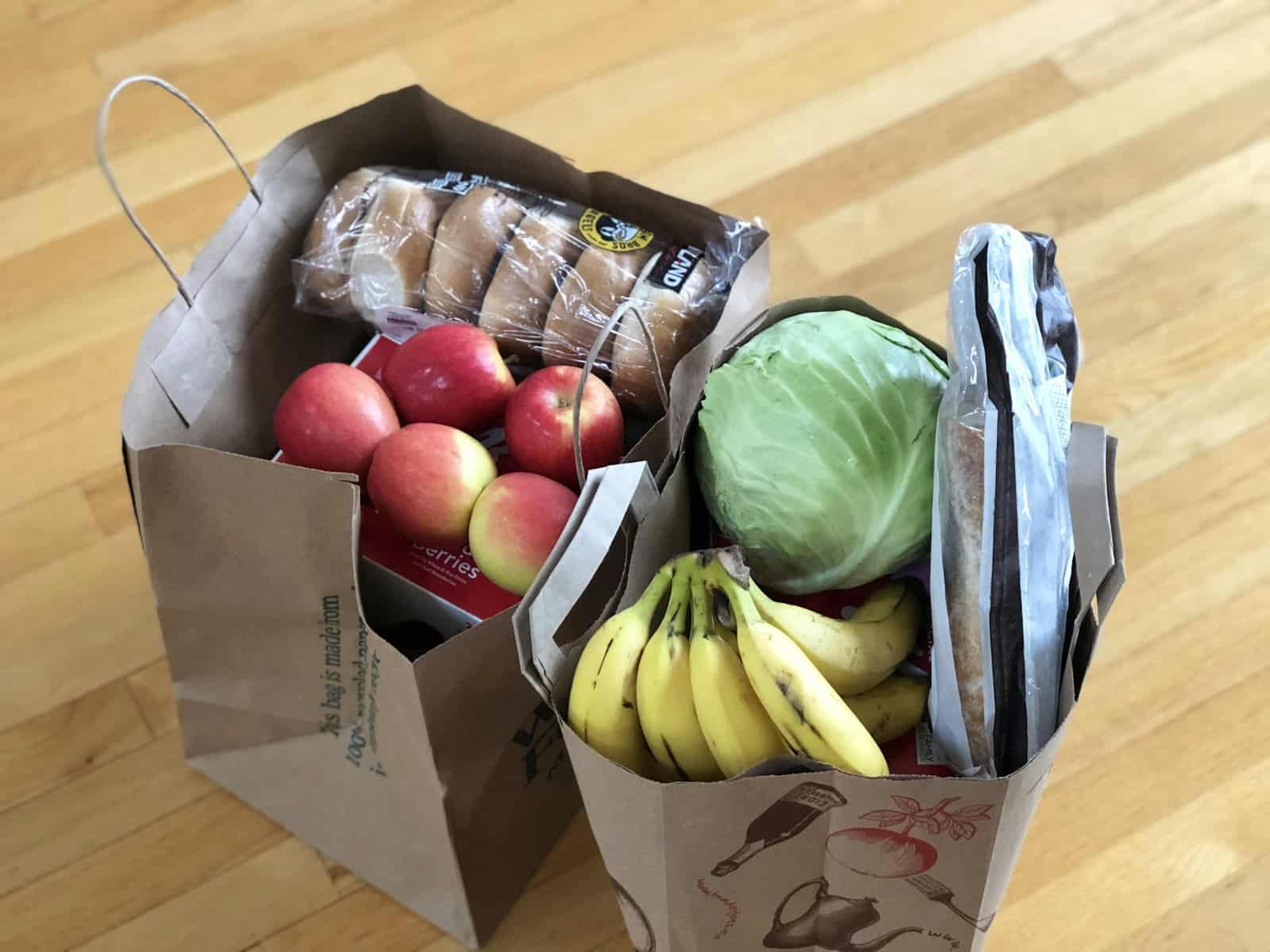 How much foster care costs a foster parent depends on the state stipend, like these paper grocery bags full of fruit and bread on a kitchen counter.