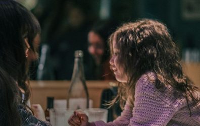 Learn how to talk to biological children about foster care and adoption, like this mother pictured speaking with her young daughter.