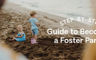 Two children play on the beach watched over by their foster parents.