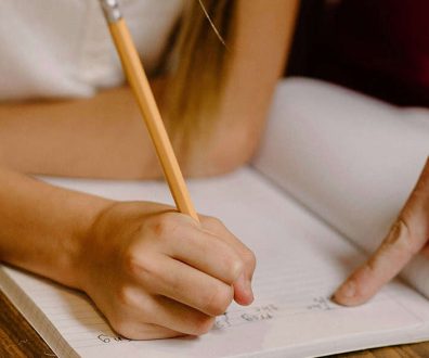 A volunteer tutors a child in foster care.